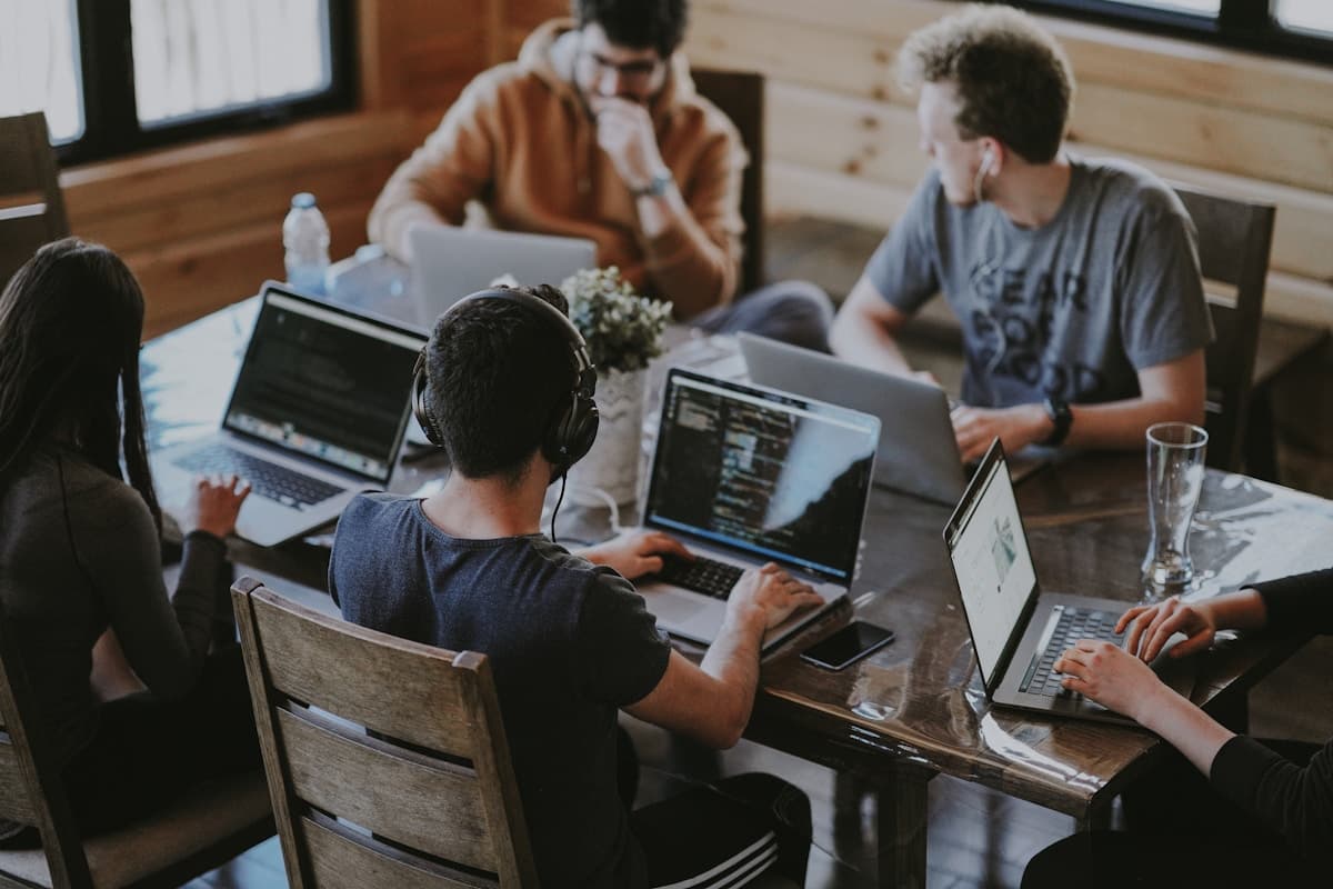 Contemporary enterprise tech team collaborating in an open-plan engineering hub